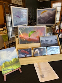 a display of paintings and paragliders on a table